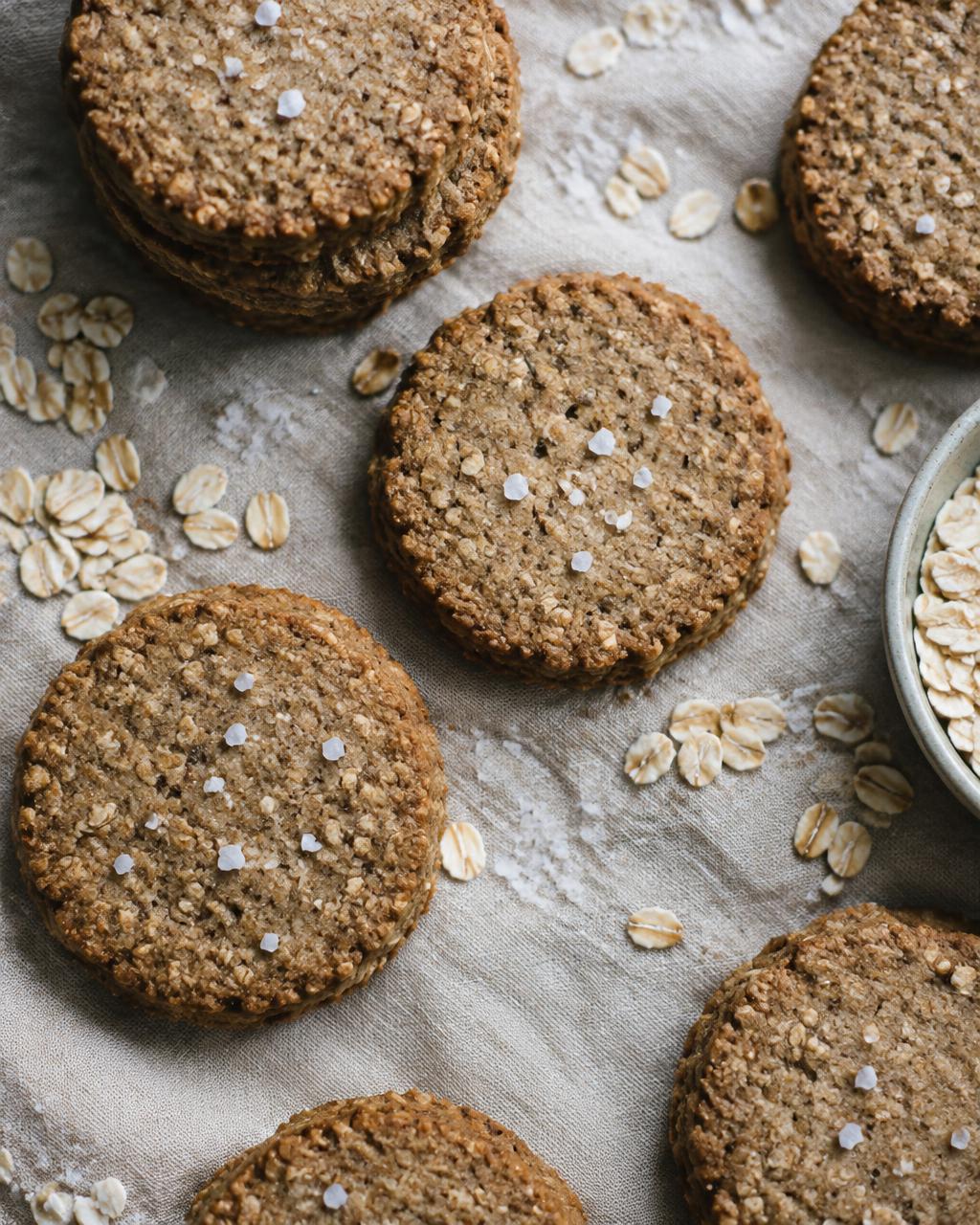 Round oat and rye sablé cookies on parchment